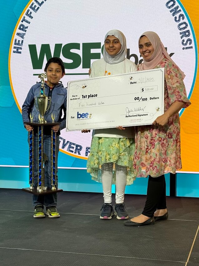 Siara Husain (middle) celebrates with her family after winning the Delaware Regional Spelling Bee competition at Delaware Technical Community College&rsquo;s Terry Campus in Dover on Saturday. PHOTO COURTESY OF DRPR STRATEGIES