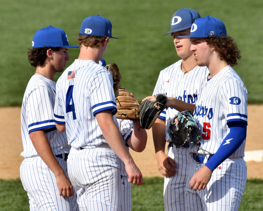 Dover infielders come to the mound to show their support for starting pitcher Kole Turner (4) in game with Salesianum.  SPECIAL TO THE DAILY STATE NEWS/GARY EMEIGH