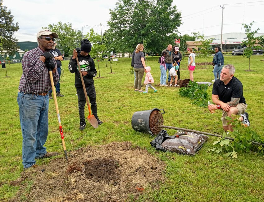 Tree lovers of all ages gathered Saturday, May 31 at Waterside Park, Fitzwater St. and Parsons Road, to plant several new saplings. In foreground, Wicomico Environmental Trust volunteer and retired educator Dan Savoy, 80, left, is with 15-year-old Park Keeper Demarcus Long, second from left, and Tom Stevenson, Assistant Salisbury City Administrator, kneeling, far right.