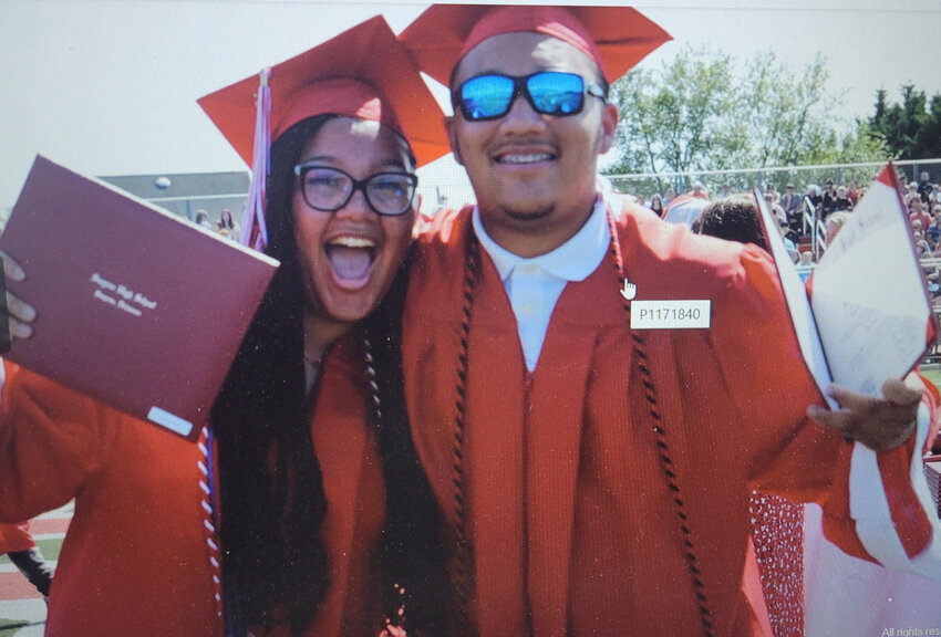 Two classmates smile for the camera.