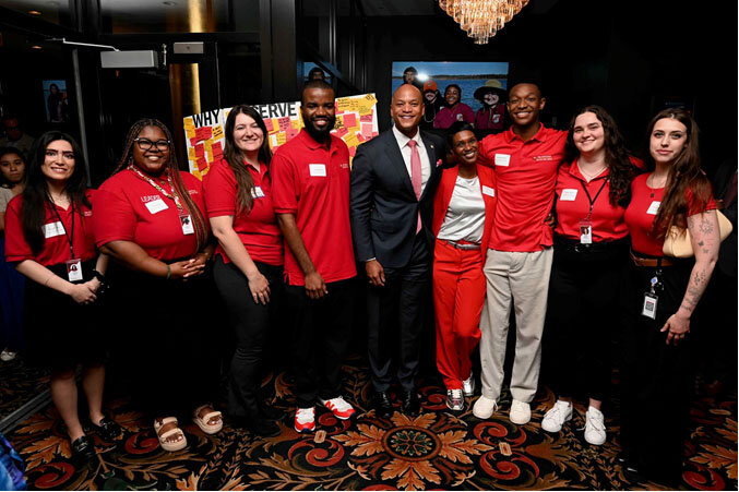 The third graduating class of the Maryland Corps/Service Year Option join Gov. Wes Moore for a group photo.