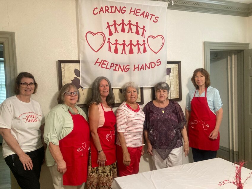 B.J. Van Kavelaar (in purple) and her team at Caring Hearts Helping Hands are getting settled into their new home in downtown Dover. DAILY STATE NEWS/MIKE FINNEY