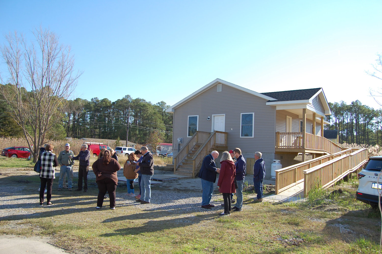 Those taking part in the dedication and blessing of the newly-completed Byrdtown Road home of Robert and Myrtle Haugh gather outside before the start of the ceremony. An extreme flood tide from Oct. 29, 2021 forced them out of their house and renovation was not possible. The former Somerset County Long Term Recovery Committee that worked after superstorm Sandy to rebuild, elevate and renovate hundreds of houses reorganized as the Eastern Shore LTRC and with major support from Mennonite Disaster Relief and partner agencies it committed to rebuild six and now possibly eight homes wrecked by last year’s flood.
