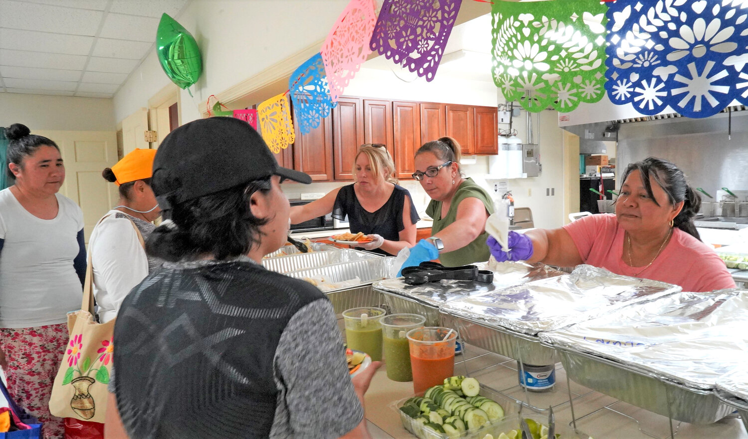 Volunteers, Amanda Priestley and Claudia Stecher served a meal from Taqueria Floritas at the event.