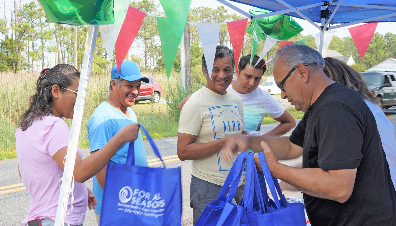 Alberto Ardaya, Interpreting Services supervisor, distributed For All Seasons resource bags.