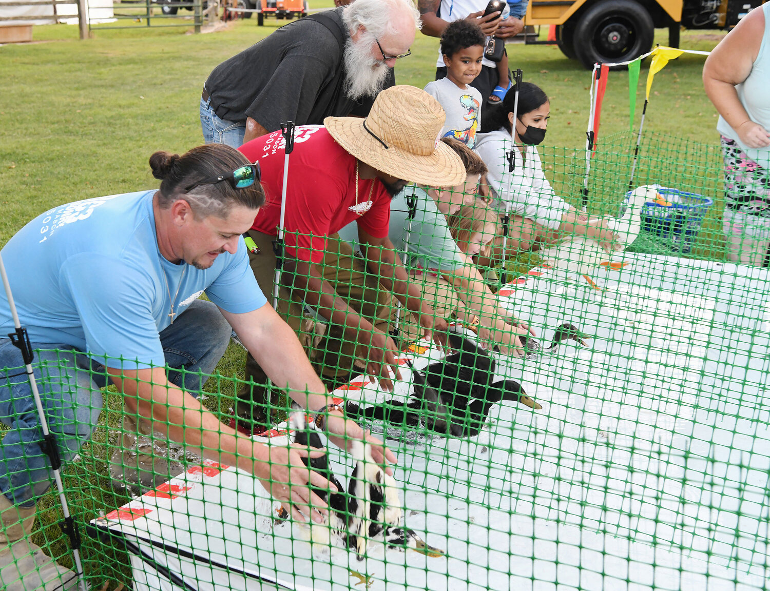 Ronnie Cain, left, of Salisbury, and William Smallwood of Seaford place their ducks into competition during the duck races.