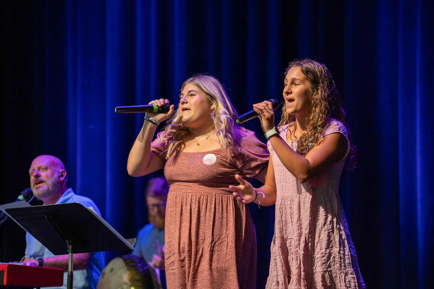 Development and alumni relations coordinator Jason Matthews and student worship leaders Keely Kondracki, left, and Layni Dukes lead the Delmarva Christian student body in praise and worship.
