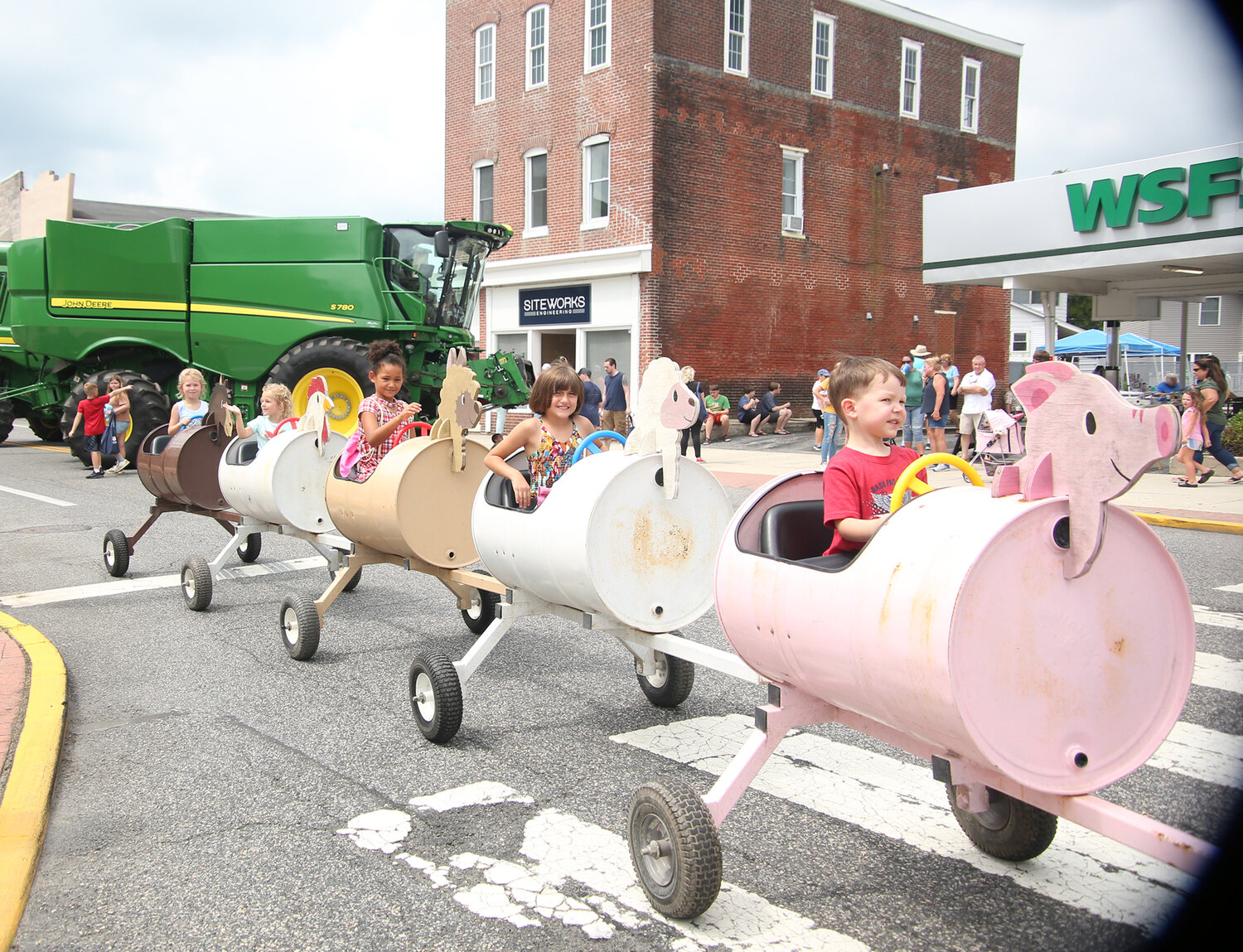 KIds enjoy the farm animal tractor ride on Commerce Street during Harrington Heritage Day.