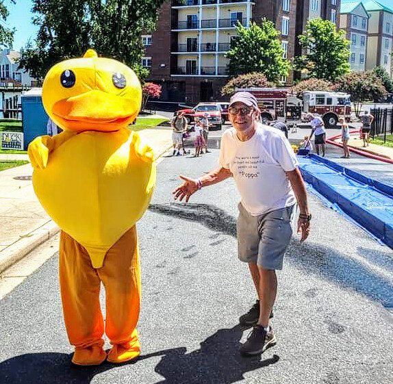 Putting the "fun" in fundraising at last year's Rotary/RFC Duck Race Fest on Court Lane,  The Duck poses with event founder Phil Reed.