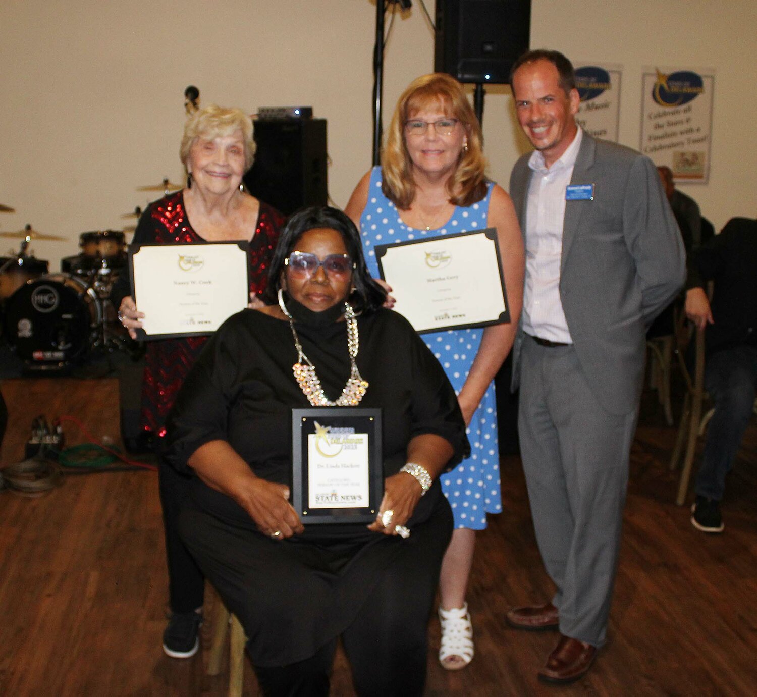 Publisher Konrad LaPrade with Person of the Year winner Dr. Linda Hackett, seated, Nancy W. Cook, left, and Martha Gery, center right, at the Stars of Delaware 2023.