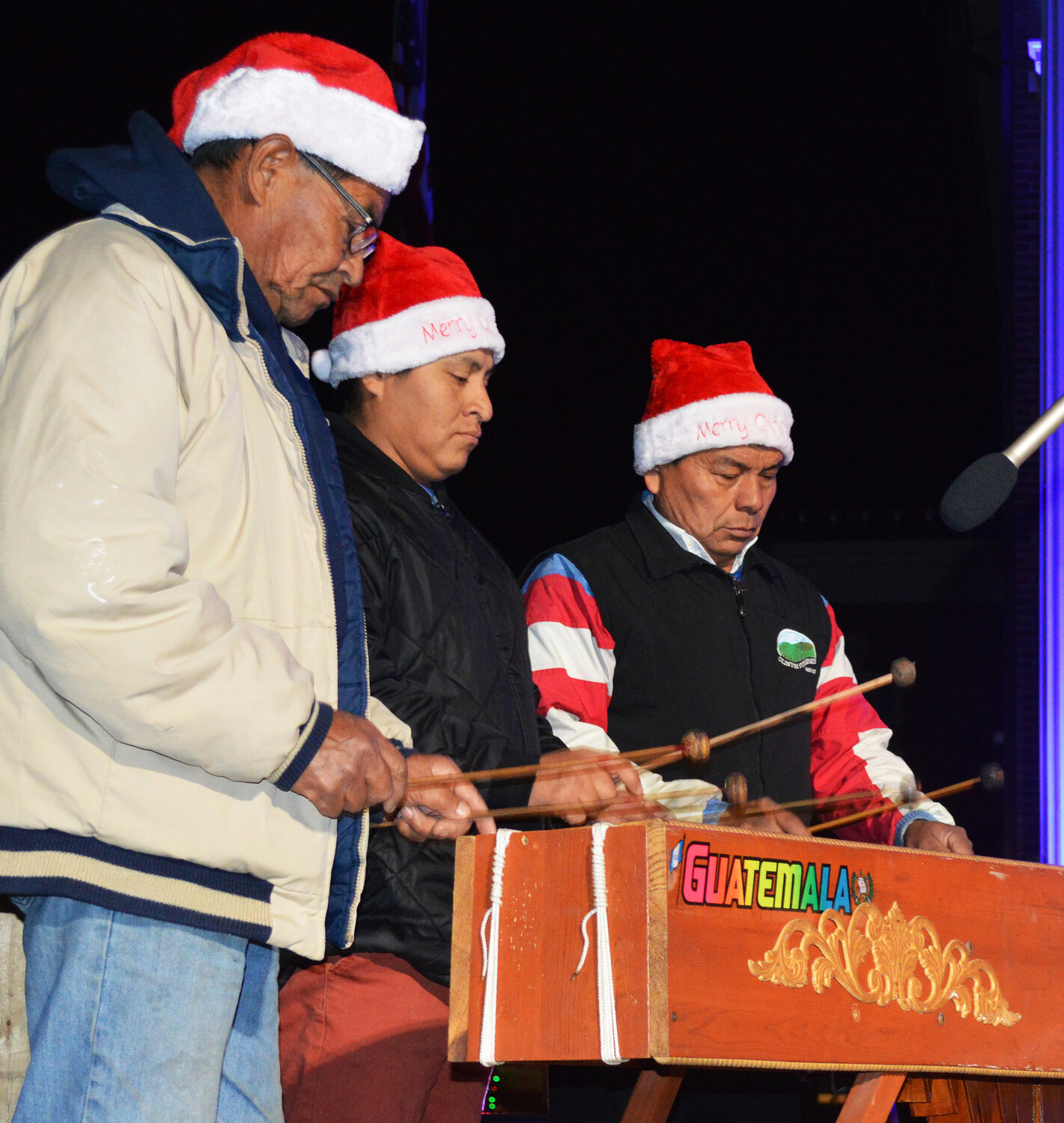 Members of Lyra Marquense perform one of their Caroling on The Circle tunes: "Feliz Navidad."