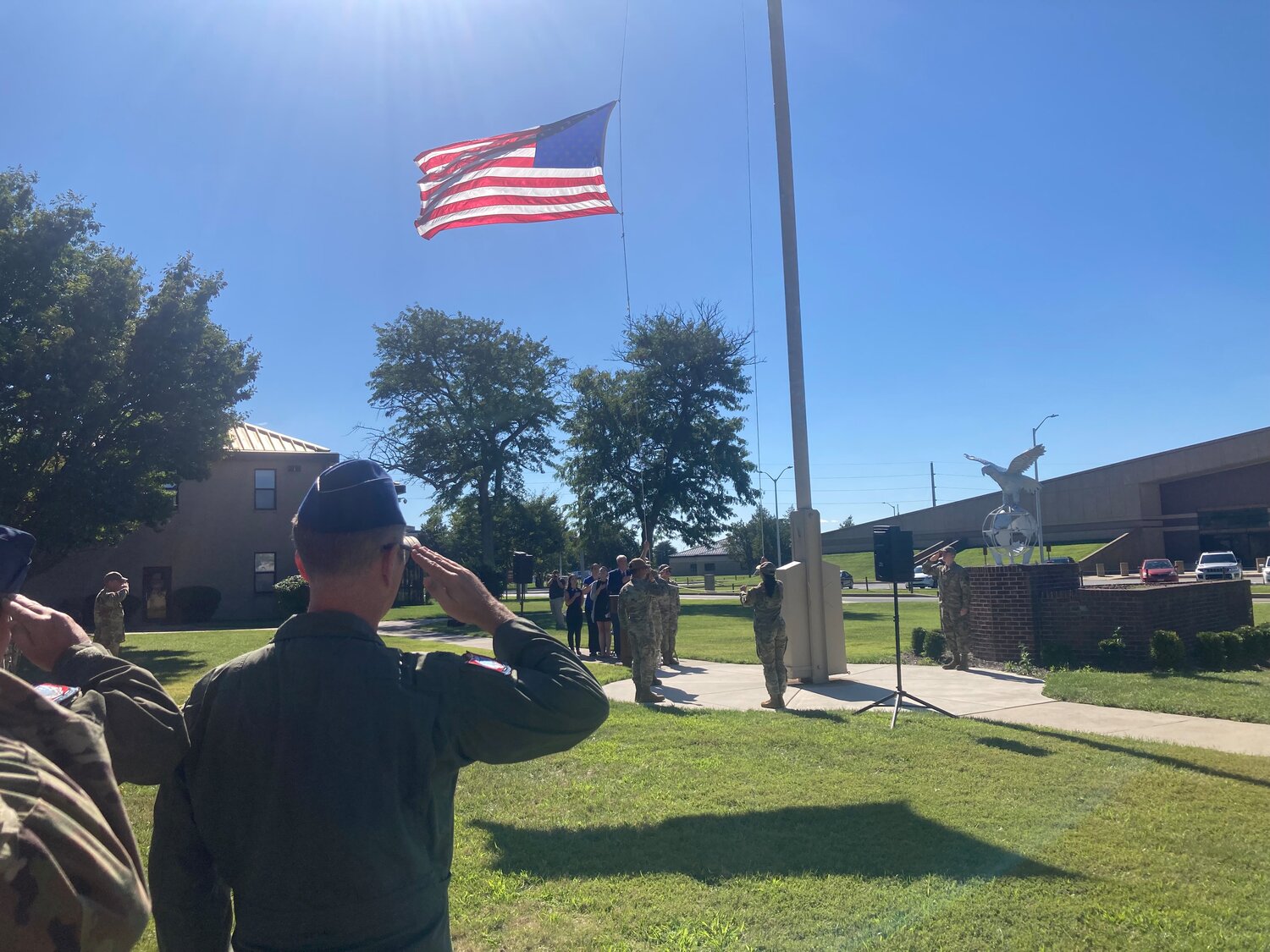 An airman salutes the American flag as it was pulled down and ceremoniously folded near the conclusion of Friday’s POW/MIA National Recognition Day Ceremony at Dover Air Force Base on Friday.