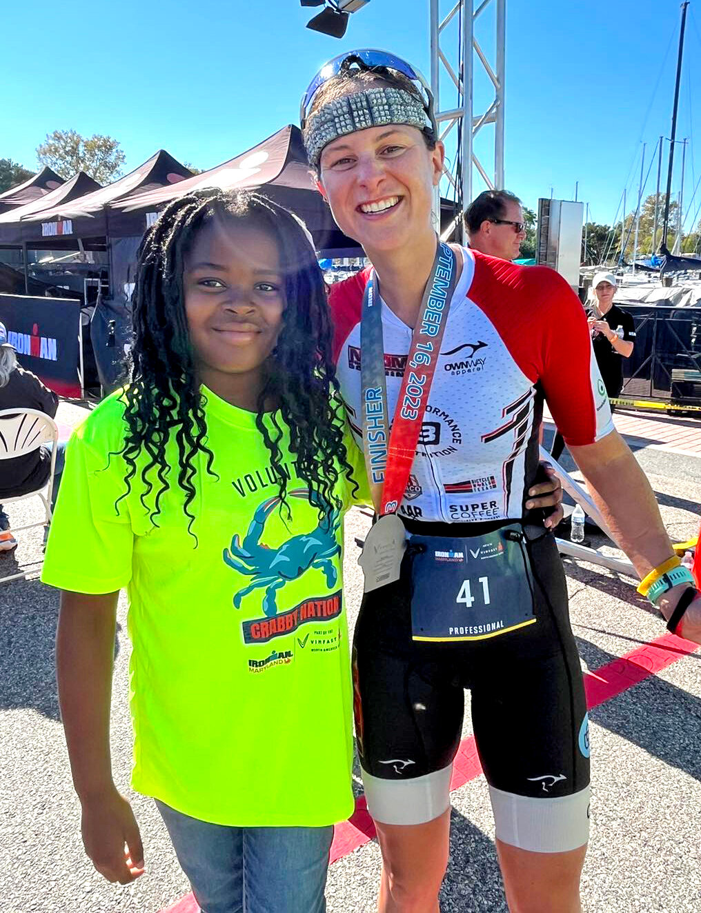 American Alice Alberts was the first woman across the finish line and received her medal from Choptank Elementary 5th grader Ja’Zyiah Mills.