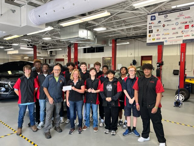 Polytech High School sophomores join Shannon Legg, auto tech instructor, and Linda Schwartz Chi, president C.F. Schwartz Toyota.