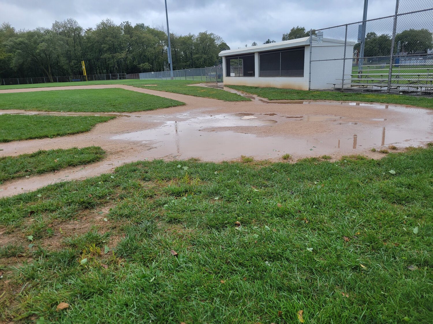 Home plate is surrounded by water at a baseball field in Silver Lake Park in Middletown Saturday morning.
