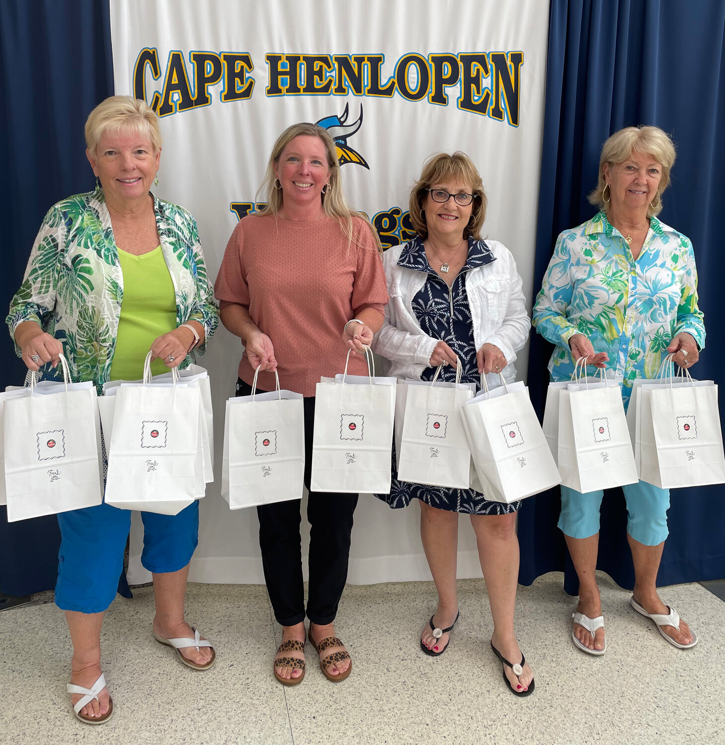 Cape Henlopen High School Principal Kristen DeGregory accepted gifts for new staff. From left, Diane Baerveldt, DeGregory, Kathy Jacobs and Lin Waggoner.