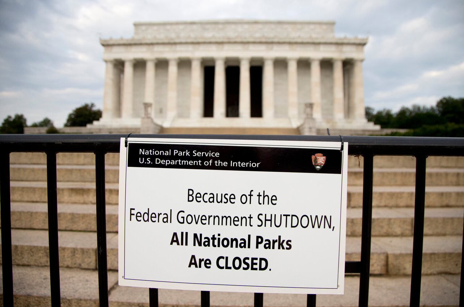 FILE - A sign reading "Because of the Federal Government SHUTDOWN All National Parks are Closed" is posted on a barricade in front of the Lincoln Memorial in Washington, Oct. 1, 2013. The federal government is heading toward a shutdown at month's end that will disrupt many services, squeeze workers and roil politics. It comes as Republicans in the House, fueled by hard-right demands for deep cuts, force a confrontation over federal spending.  (AP Photo/Carolyn Kaster, File)