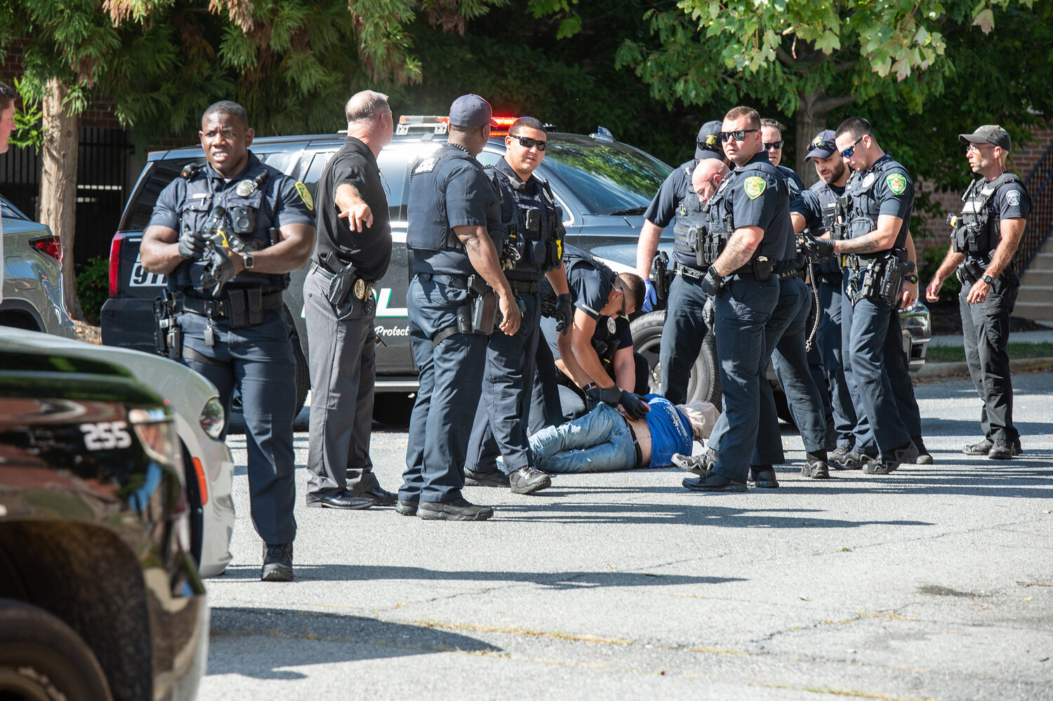 Dover Police officers handcuff a wanted man while being arrested on South Bradford Street in Dover on Monday.