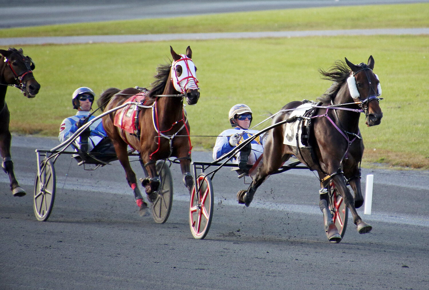 Kim's Command, driven by Russell Foster, leads Unbelievable Kemp,  driven by Art Stafford Jr., at the half of the second race Wednesday at Harrington Raceway. Unbelievable Kemp won the race in 1:59 and paid $11 to win.