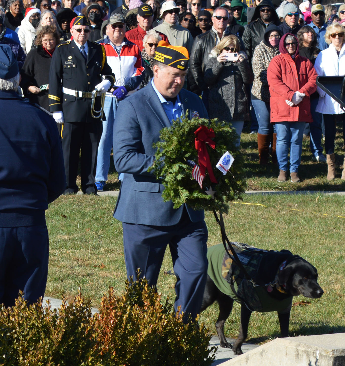 Mark Miller, a retired member of the U.S. Army, joins his service dog, Georgie, in placing a wreath during last year's Wreaths Across America ceremony at the Delaware Veterans Memorial Cemetery in Millsboro.