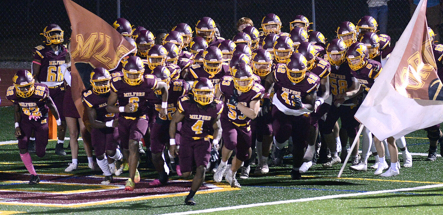 DenNare Horsey (4) leads the Milford Buccaneers out onto the field to meet Sussex Tech Friday night. SPECIAL TO THE DELAWARE STATE NEWS/GARY EMEIGH