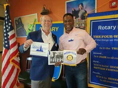 Will Grimes, right, president of the Dover Downtown Rotary Club, exchanges flags with Jerry Bilton of the Newark Rotary Club, joining a project to bring water to drought-stricken Kenya.