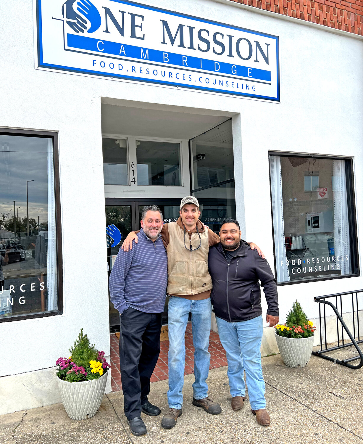 From the left are Paul Dendorfer of Blue Ruin, Rick Travers Jr. of Simmons Center Market, and Chris Rojas of Taqueria Floritas. These three Cambridge businesses are donating the food and hosting a free Thanksgiving dinner at One Mission Cambridge on Nov. 20 at 4 p.m.