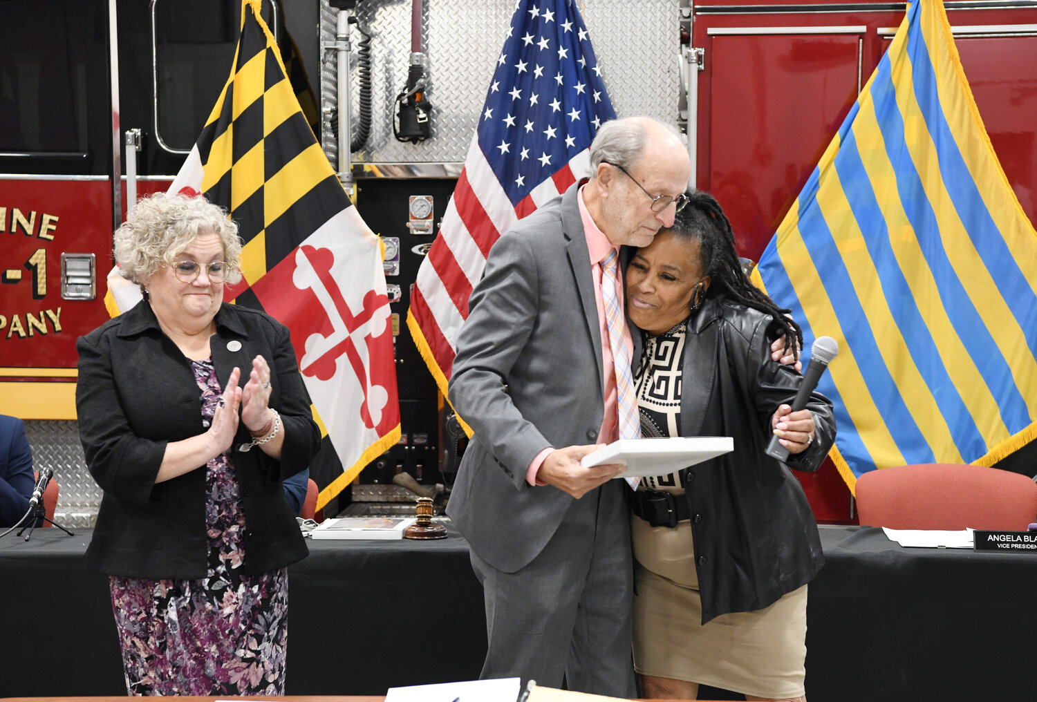 Council members Angela Blake and April Jackson present a celebration plaque to outgoing Mayor Jack Heath.