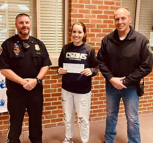 Cambridge Police Chief Justin Todd and Lt. Robert Ball presented a $1,000 check to Casey O’Brier, athletic director at Cambridge South Dorchester High School. The donation is to support the Vikings football team as they travel for Maryland state high school playoff games.