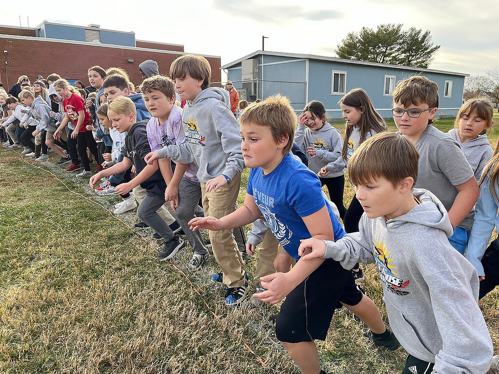 Everyone knows about Turkey Trots, but what about a Wild Goose Chase? This has been an annual tradition at Warwick Elementary School since 2017, and this year was no exception. The tricky goose was everywhere, from chasing children approaching the finish line, to roosting on the roof, to making a few new friends among the Huskies. This year the runners in the Final of the Wild Goose Chase represented their class houses. The overall winners were Brooks Daniels and Aubrie Mills, both from the House of Altruismo. Kudos, too, to the several runners who gave up their own chances in the final to help a fellow student who fell. DCPS Photos