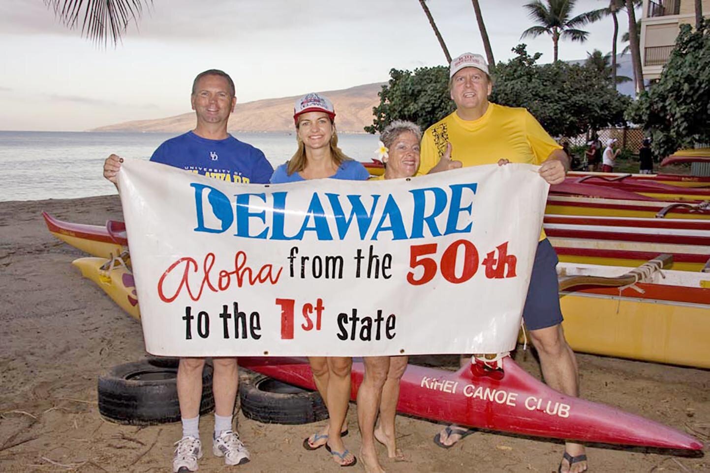 Residents of Maui will celebrate Delaware Day on Thursday. Shown with the banner are, from left, Andy Stehl, Amy Hill Crowe, Adele Rugg and Stephen Luksic -- native Delawareans who now live on the island of Maui.