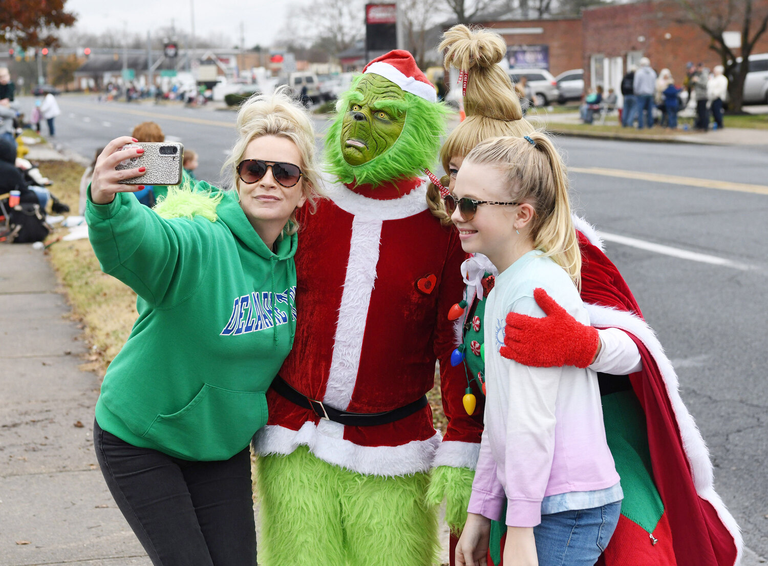 Jenny Hoffman, left, of Laurel takes a selfie with the Grinch and Cindy Lou Who with her daughter, Danica Banks, 11, also of Laurel.