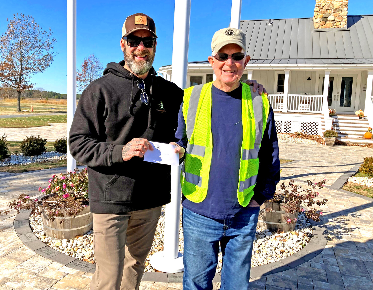Cambridge Lions club President Gene Williams, at right, made a donation to Hugh Middleton of Patriots Point in Taylors Island. Patriots Point provides a healing place for military veterans.