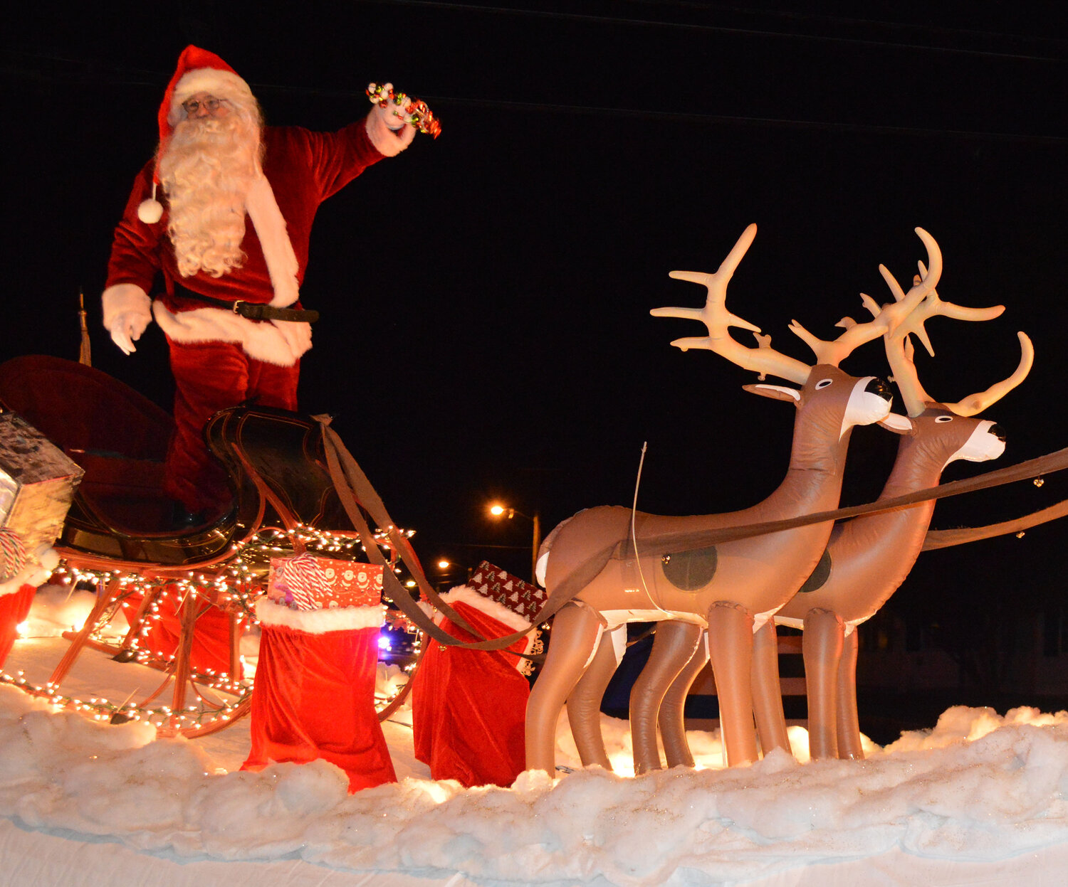 Santa Claus arrives on a float provided by Boy Scout Troop 95 at the end of the Georgetown Christmas Parade on Thursday.