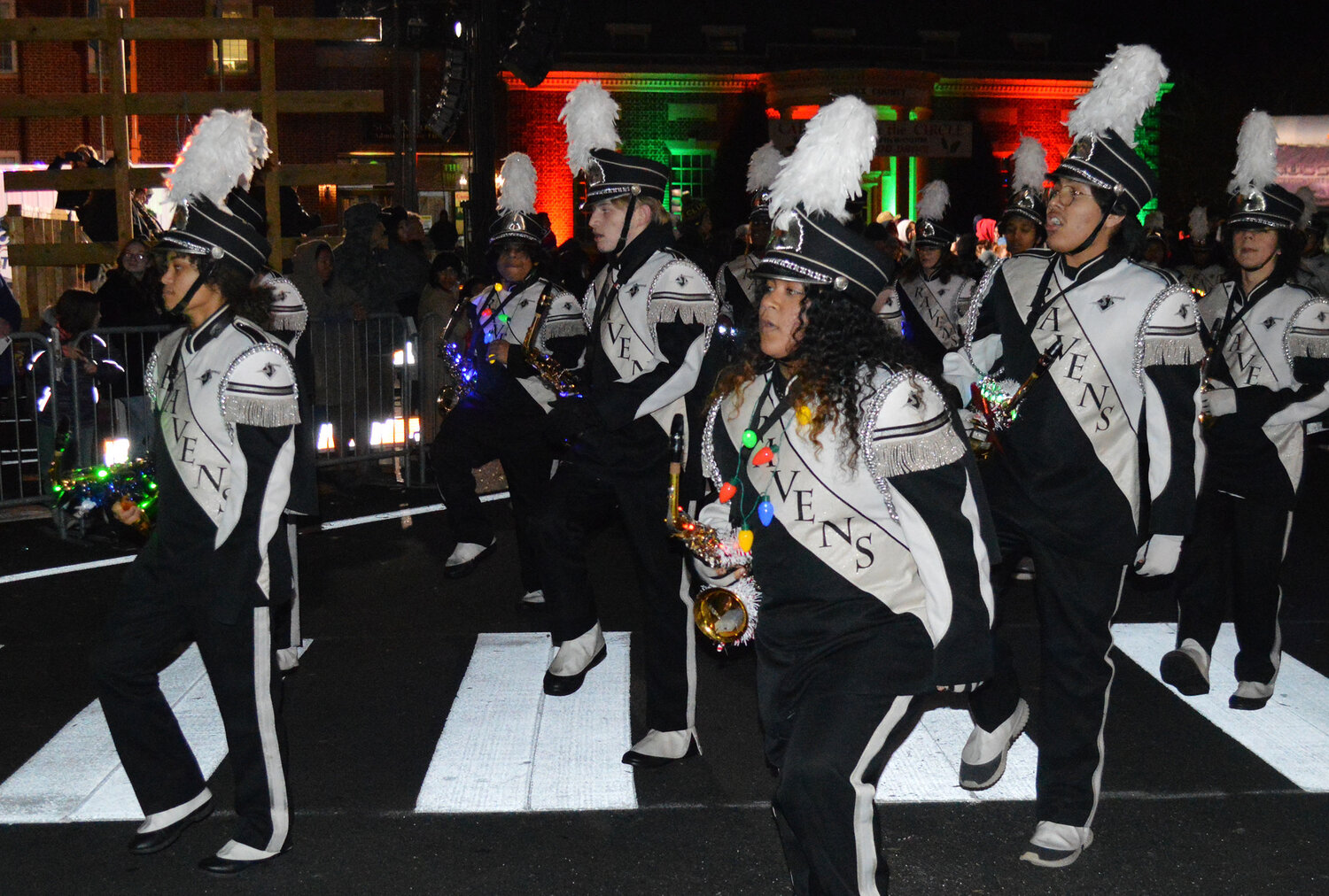 Sussex Technical High School's Raven Nation marching band high-steps through The Circle during the Georgetown Christmas Parade on Thursday.