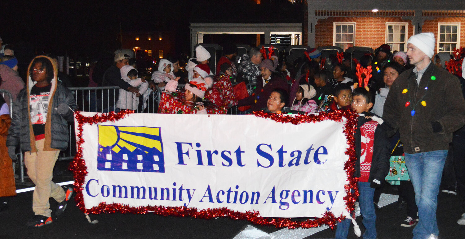 The First State Community Action Agency marches in the Georgetown Christmas Parade on Thursday.
