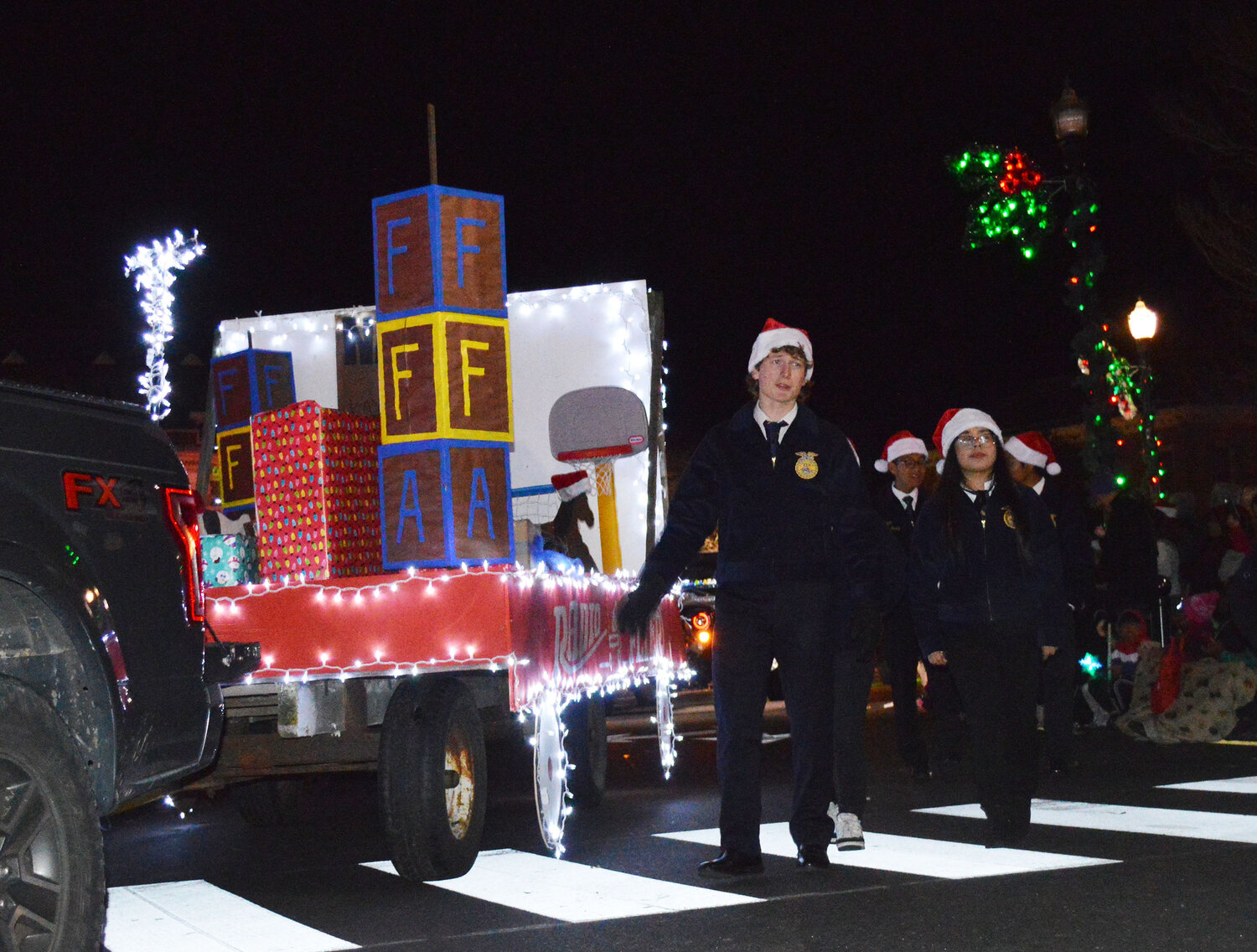 The Sussex Central High School National FFA Organization entry loops around The Circle in Thursday's Georgetown Christmas Parade.