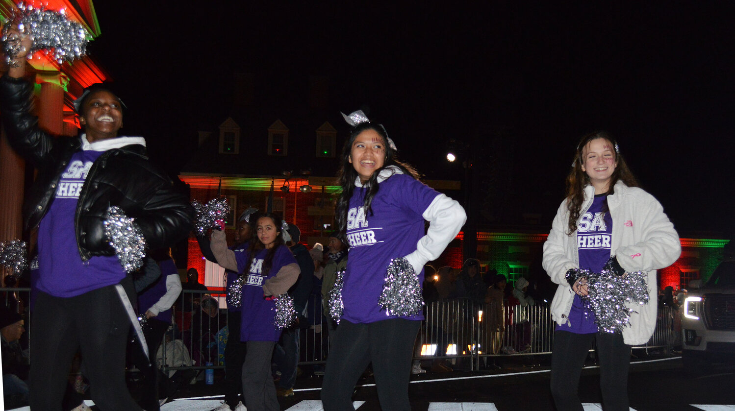 Members of the Sussex Academy cheer squad show their spirit in the Georgetown Christmas Parade on Thursday.