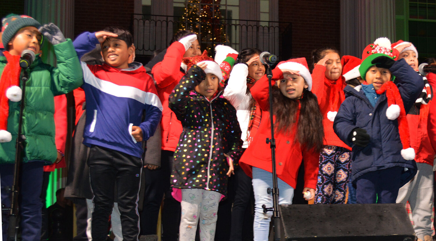 A popular Caroling on The Circle staple, the St. Michael the Archangel Parish children's choir performs at Thursday's event in Georgetown.