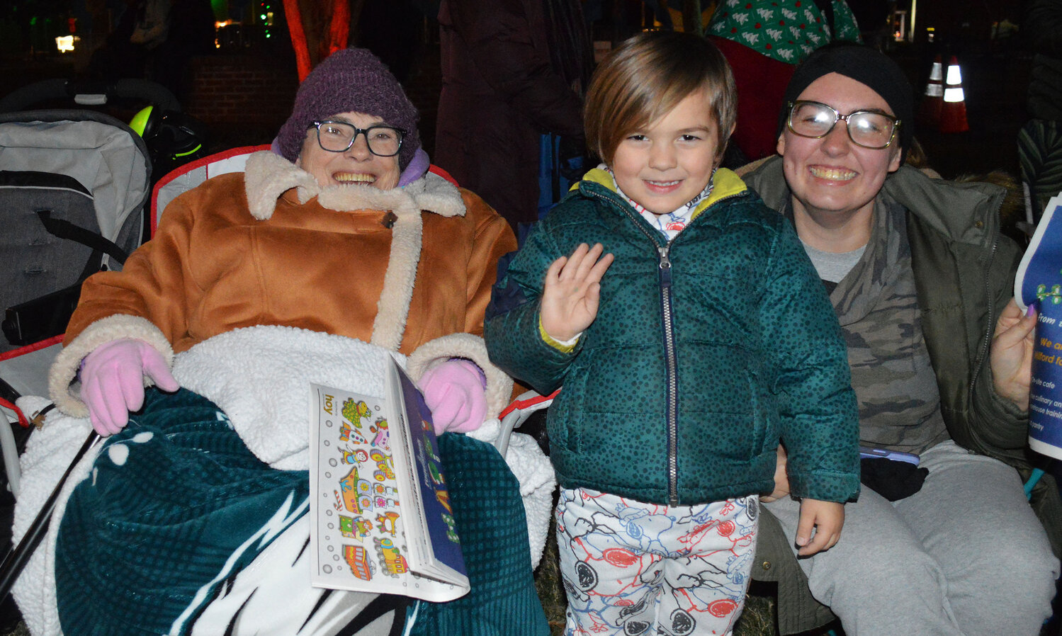 Early arrivals Thursday for Caroling on The Circle and the Georgetown Christmas Parade, are, from left, Pat Emmett and her great-grandson, Asher Evans, and granddaughter, Kaitlyn Evans.