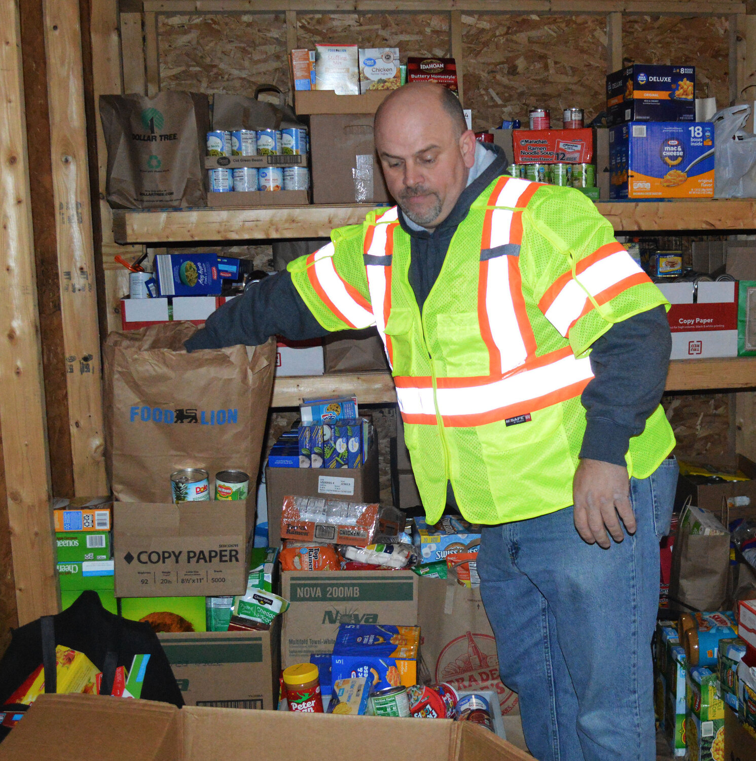 Sussex County employee Dale White inventories donated food during the collection drive during Caroling on The Circle on Thursday.