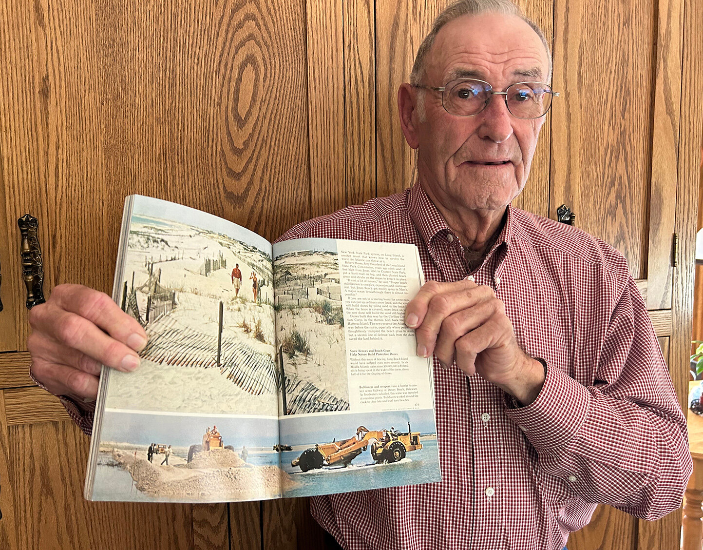 Leroy Betts shows the 1962 National Geographic which featured a photo of him restoring the beach north of the Indian River Inlet.