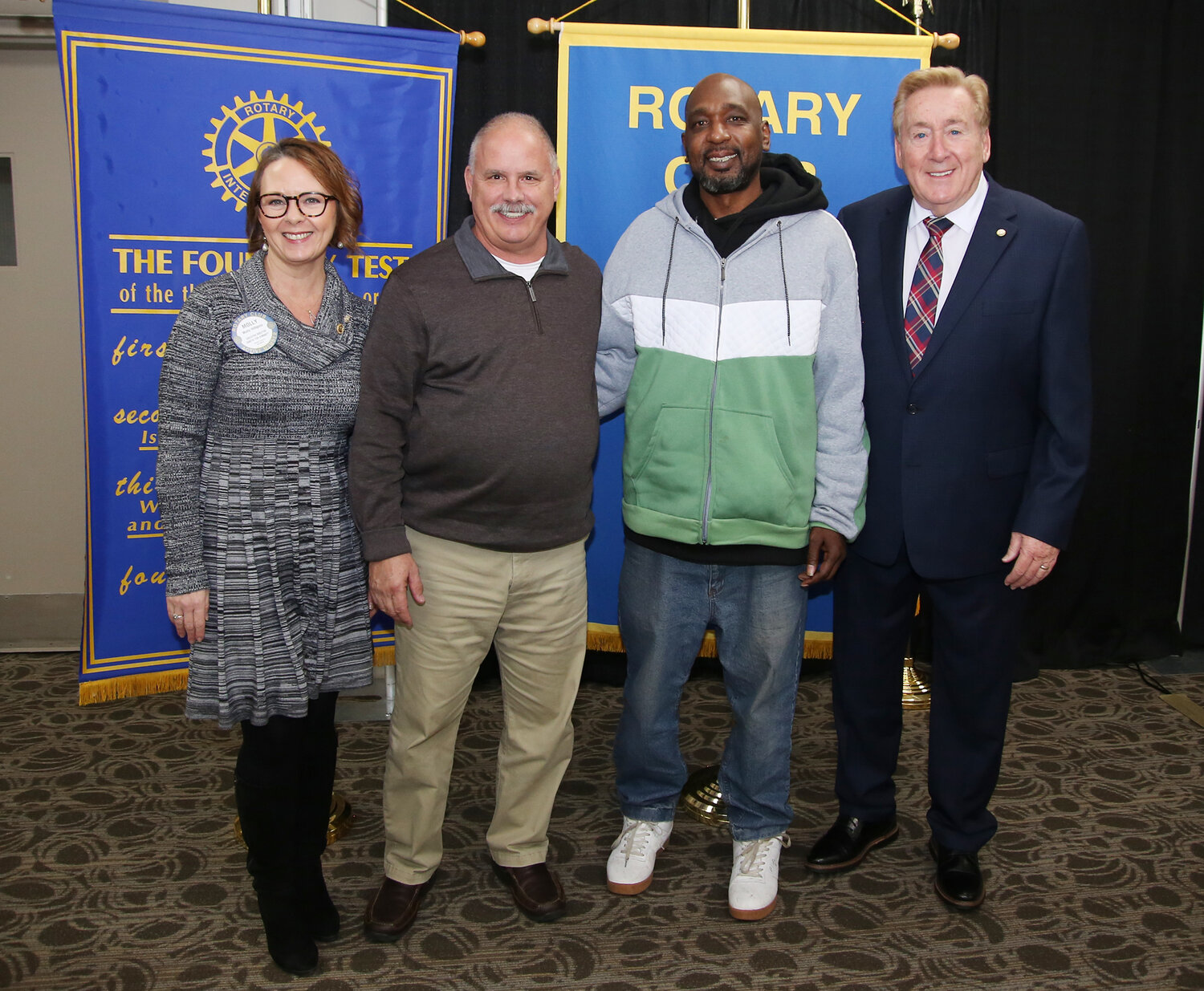 From left, Molly Hilligoss, president of the Rotary Club of Wicomico County, "Hero Award" recipients Bill Suess and Alfred Johns, and ceremony emcee Don Hackett pose after a luncheon Tuesday, Feb. 6, at the Wicomico Civic Center.