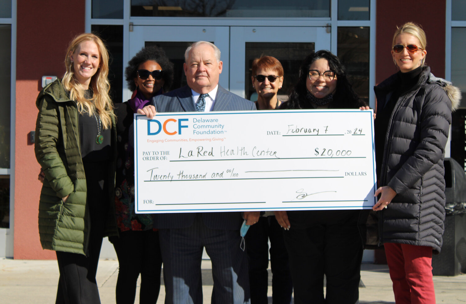 From left, Rachel Hersh, La Red Health Center's deputy director; Viola Banks of La Red's administration; CEO Brian Olson; Nancy Bratmeyer and Joana Torres of the center's administration; and Jessica Gordon, southern Delaware philanthropy officer for the Delaware Community Foundation, take part in the check presentation.