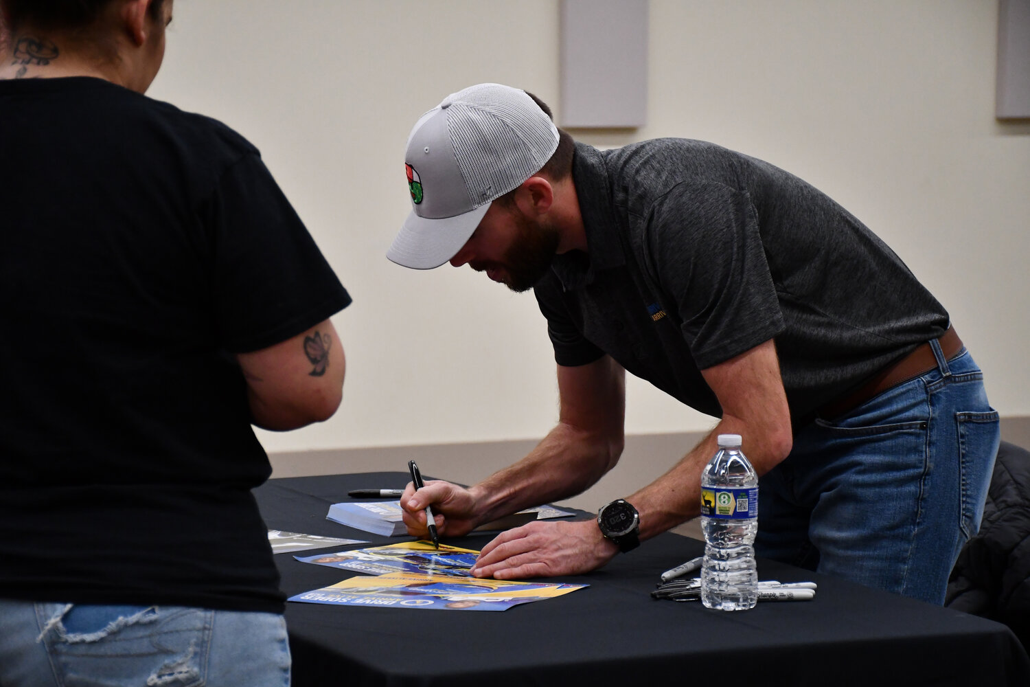 NASCAR driver Ross Chastain signs autographs for his fans in Dover on Thursday.