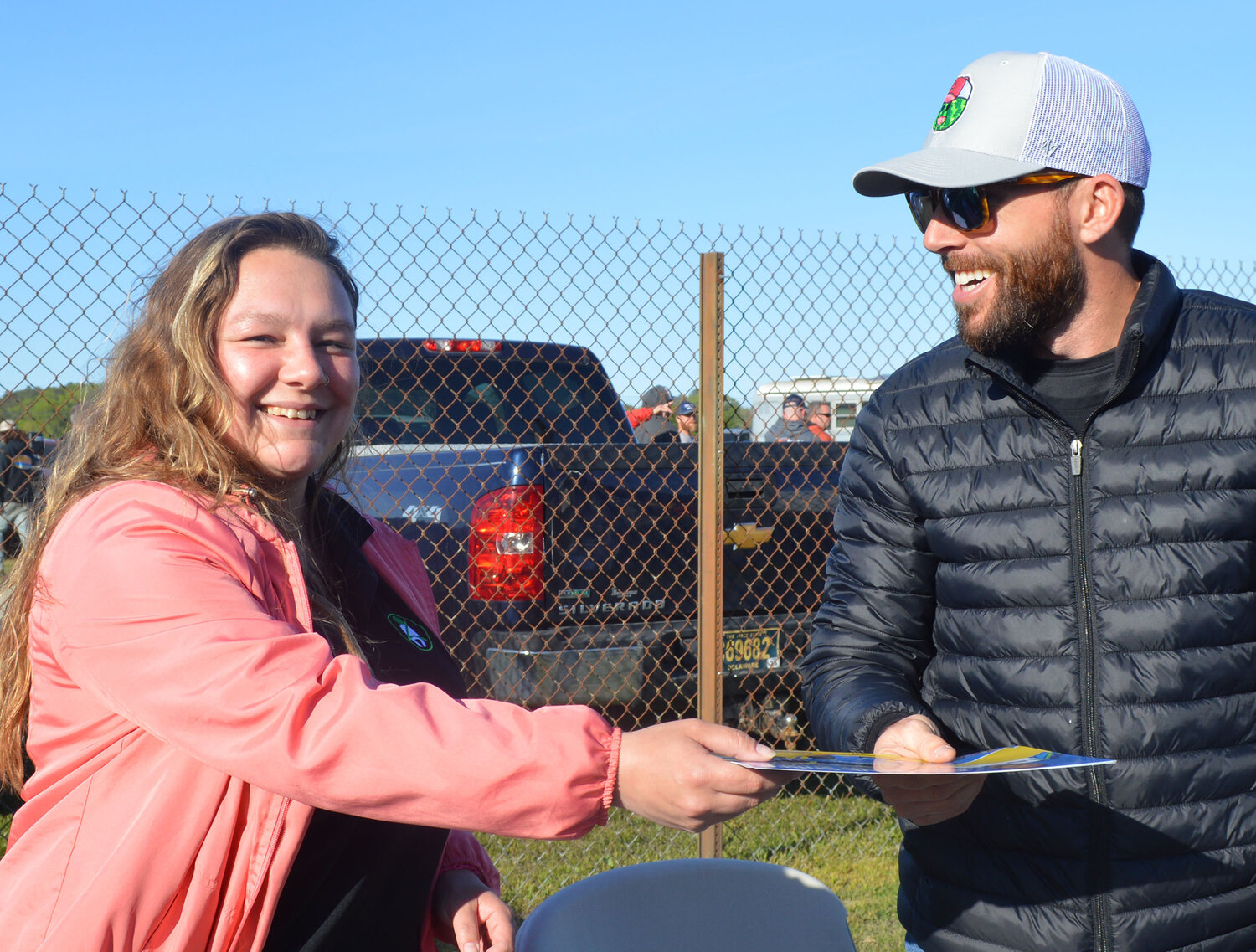 Meghan Niddrie, Community Relations Officer for the Office of Highway Safety, gets an autograph from NASCAR driver Ross Chastain Friday during the Melvin Joseph Memorial event at Georgetown Speedway. Chastain is a goodwill ambassador for the Office of Highway Safety, promoting safe driving.