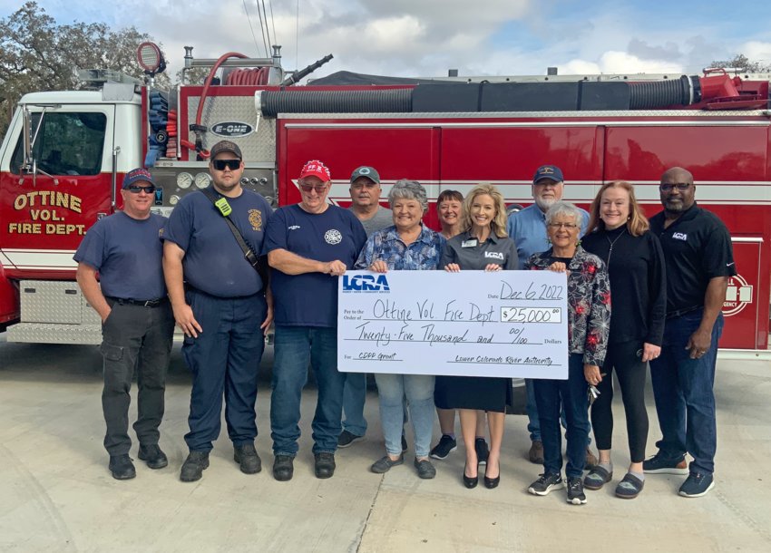 LCRA representatives present a $25,000 grant to the Ottine Volunteer Fire Department for a new brush truck cab and chassis. The grant is part of LCRA&rsquo;s Community Development Partnership Program. Pictured, from left to right, are: Robert Riley, firefighter; Donnie Grauke Jr., second assistant fire chief; John Everett, fire chief; James &quot;Bubba&quot; Boehm, VFD board member; Pam Walshak, VFD president; Debbie Everett, VFD secretary/treasurer; Margaret D. &ldquo;Meg&rdquo; Voelter, LCRA Board member; Ray Colmenares, VFD audit committee; Kay Floyd and Tina &quot;DeDe&quot; DeStefano, VFD board members; and Rick Arnic, LCRA Regional Affairs representative.