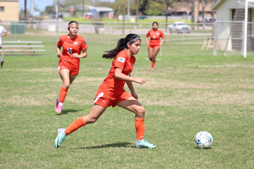 Lady Apaches junior Bella Aguero (2) moves the ball down field in   the final home game against the YWLA Lady Cardinals Monday,   March 11.