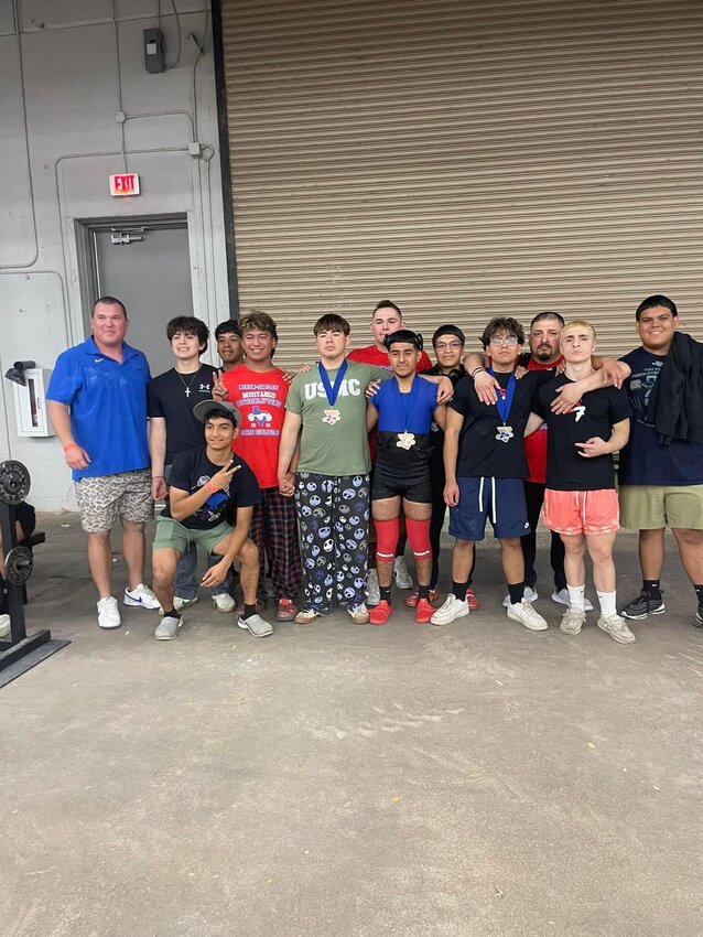 The 2024 Nixon-Smiley Mustangs powerlifting team and coaches celebrate at the state powerlifting meet in Abilene Thursday, March 22.