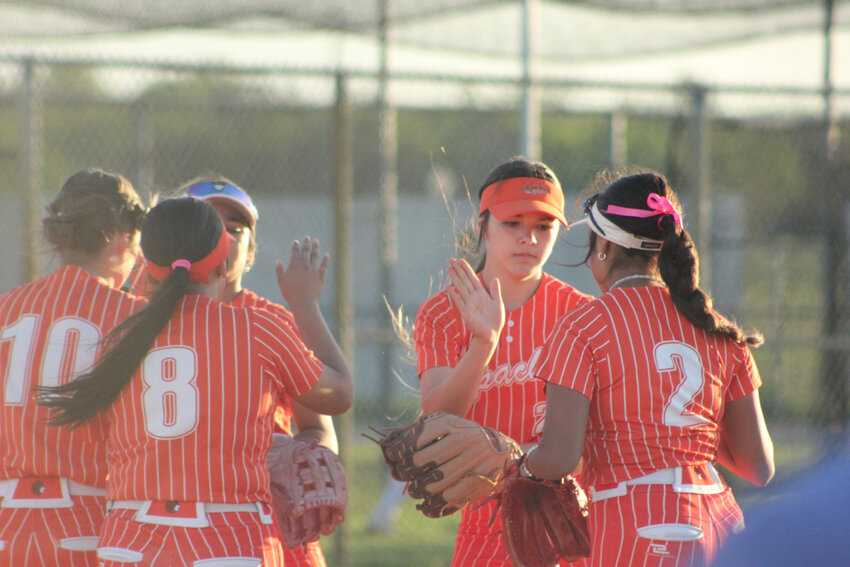 The Gonzales Lady Apaches celebrate after a strike out on the La Vernia Lady Bears Tuesday, April 2